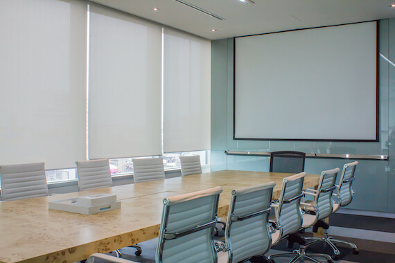 Blackout roller shades on windows in hospital meeting room